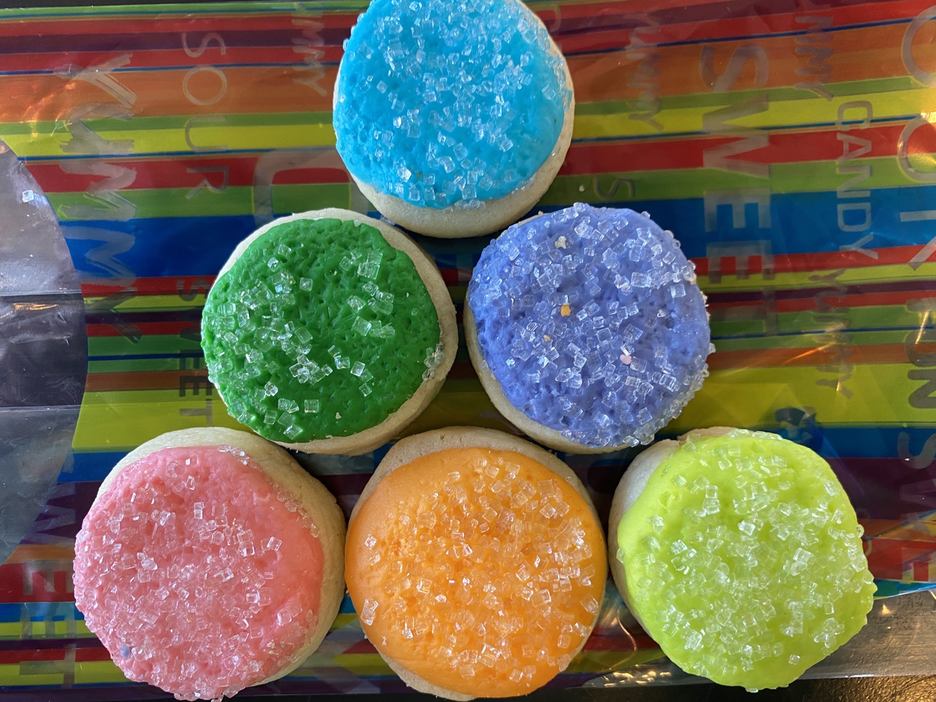 Sugar cookie buttons with brightly colored frosting and
      crystal sugar.