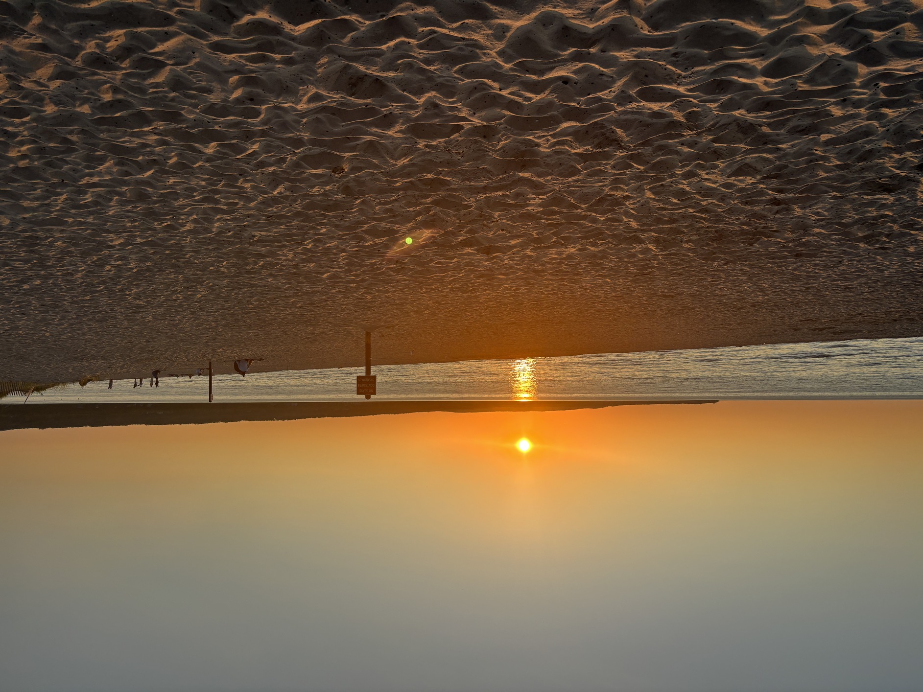 The last
      bit of sun for Tuesday, July 1, 2025 is glowing in the sky over
      Menonaqua Beach.