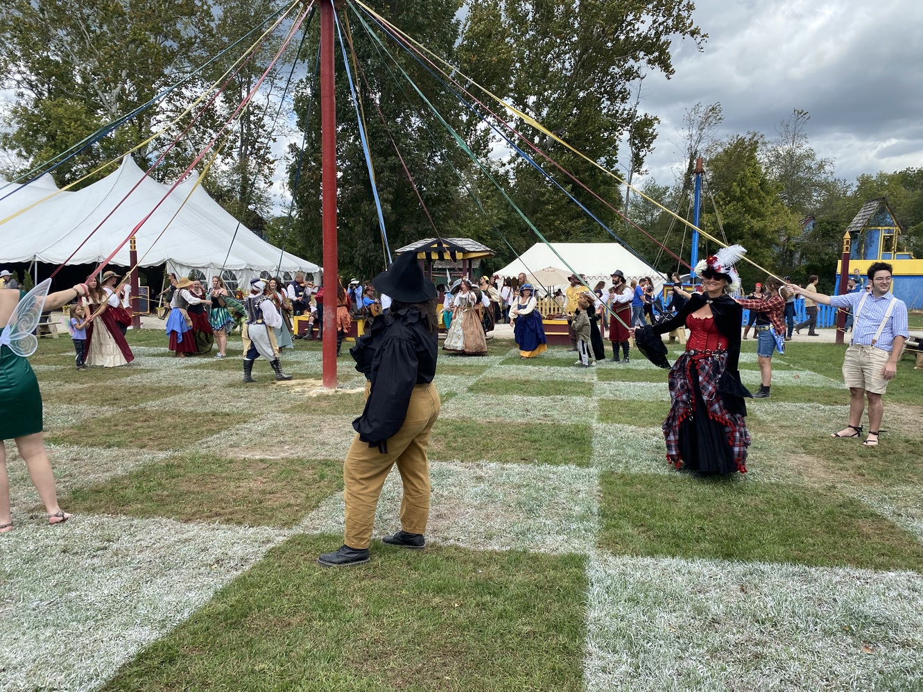 Rally around the Maypole at the festival.