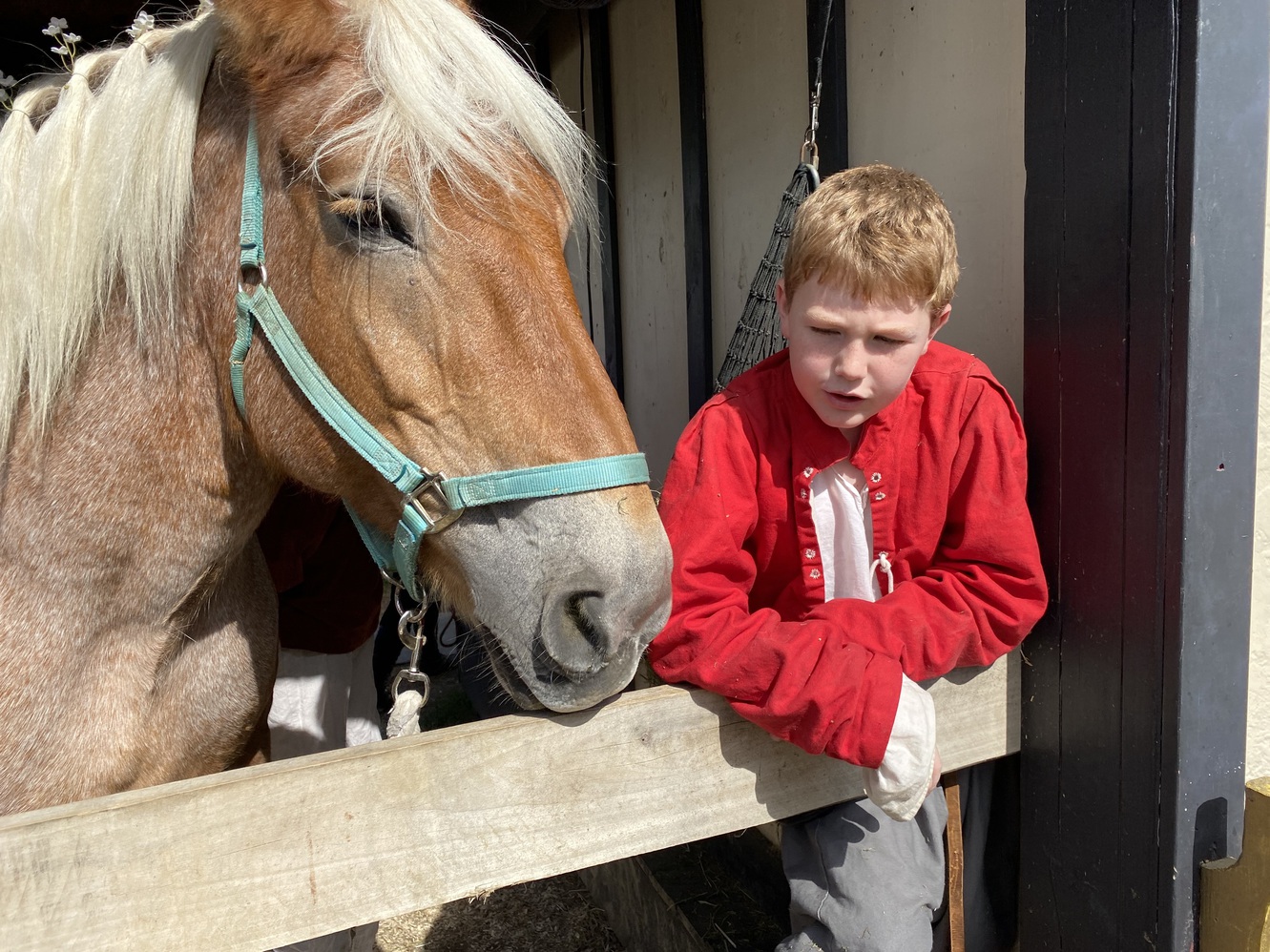 A stable boy in costume with his horse, Belle.