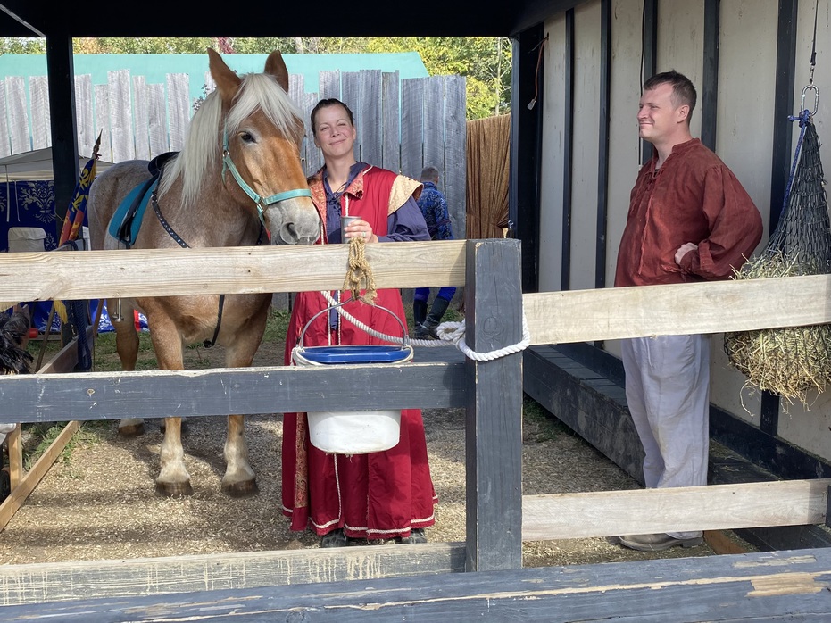 Dame Jessica poses with her horse Belle before the jousting
        tournament.